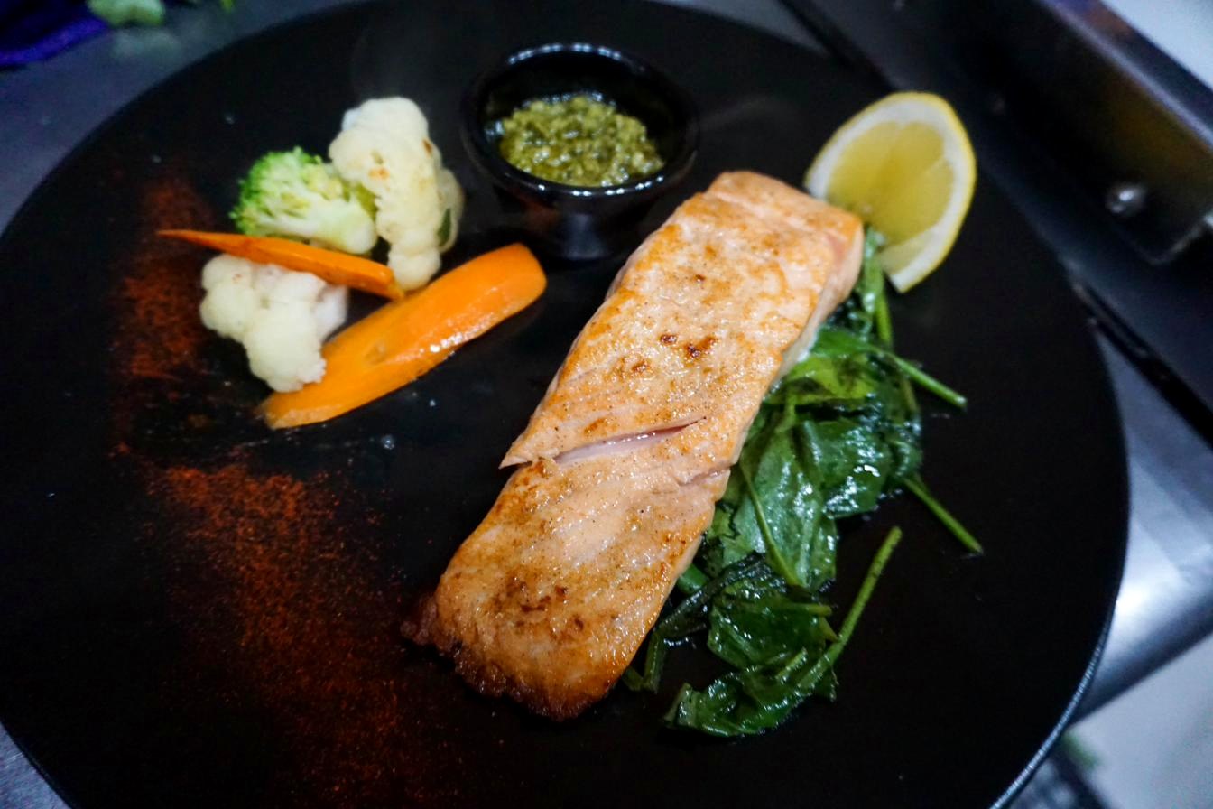 Grilled salmon steak with butter garlic or pesto sauce