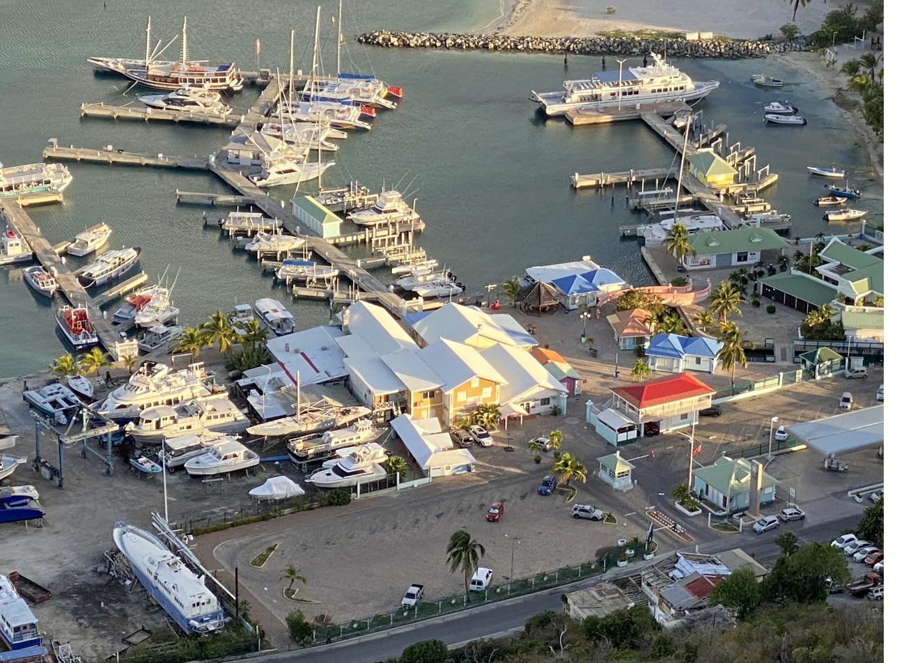 An aerial view of Bobby's Marina at golden hour — the boats at rest, the marina village, the bay beyond